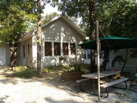 Tree Shaded Cabin with picnic table and fire-pit with lake view.