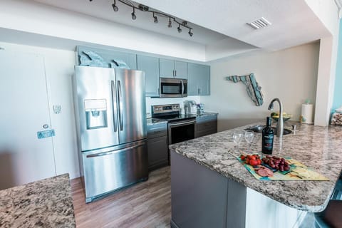 Fully equipped ocean-front kitchen with breakfast bar for easy meals.