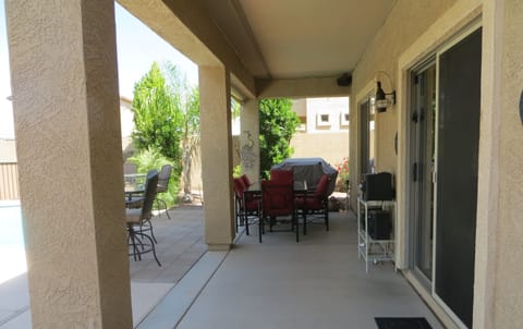 COVERED PATIO WITH GAS GRILL AND 6 SEAT OUTDOOR DINING SET