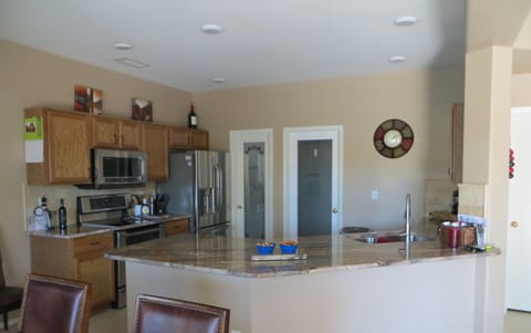 FULLY EQUIPED KITCHENWITH GRANITE COUNTERS AND FOOD DISPOSAL