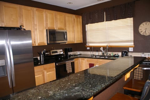 Large, open kitchen with bar seating for 4 