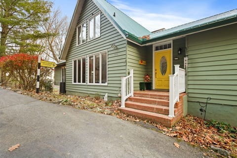 The front door is at the top of the driveway.