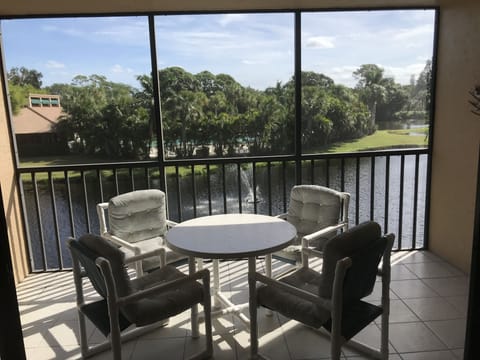East facing Lanai view of lakes and trees. Pool is behind the trees.