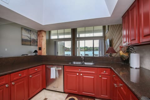 Spacious kitchen with full view of living room and lake. Very well equipped.
