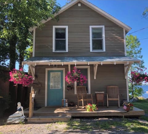 Watch the villagers go by from the rocking chair front porch 