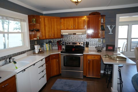 Kitchen area, new countertops, retained cabinets and porcelain sink.  