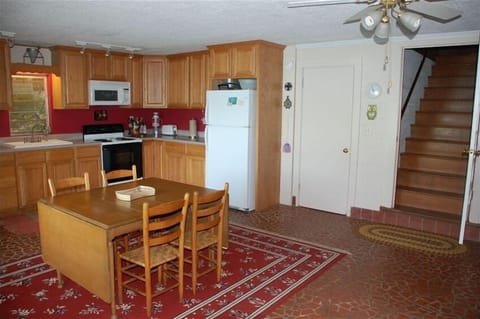 Kitchen and stairs. Door into downstairs bathroom.