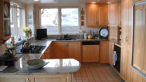 Kitchen with gas range, Sub Zero fridge, and granite counter tops