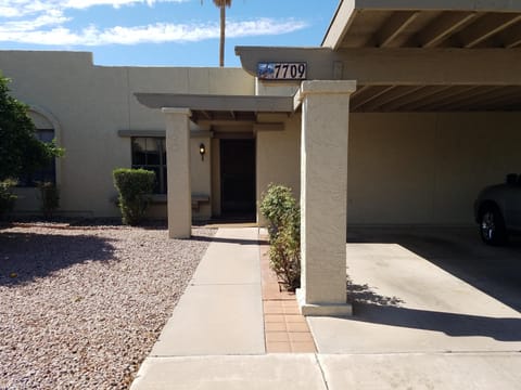 Condo has one car carport facing north.