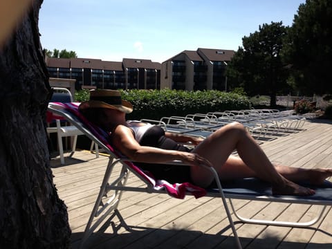 Relaxing on the sunning deck . Pool and hot tub open Mid May until October 1st
