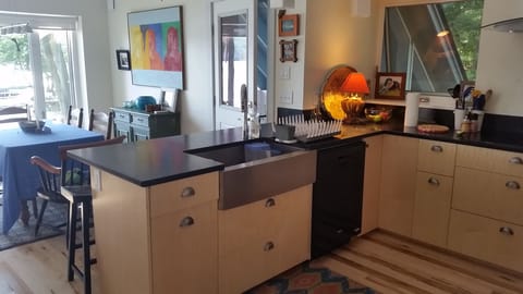 The cook's kitchen features a farmhouse sink, dishwasher and soapstone counters.