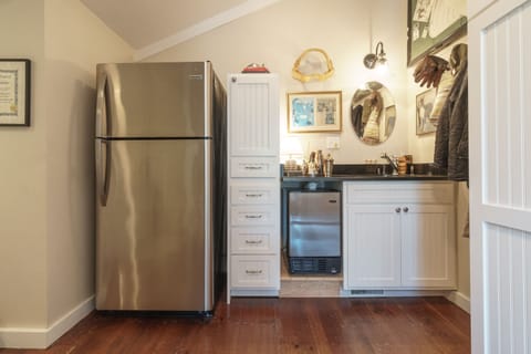 Fridge in laundry/bar area off kitchen.