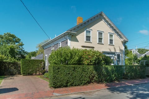 Front with driveway that holds four cars.
