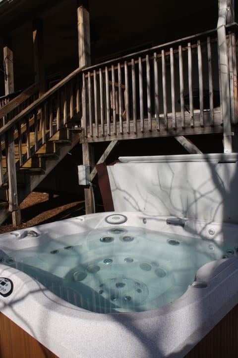 Six-person hot tub just off back porch & overlooking rushing stream.
