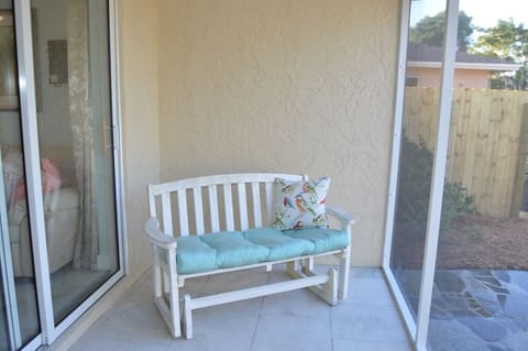 Screened in back porch overlooking the patio and private backyard.