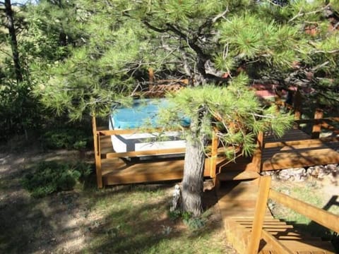 Hot Tub in the trees showing stairs from the back deck