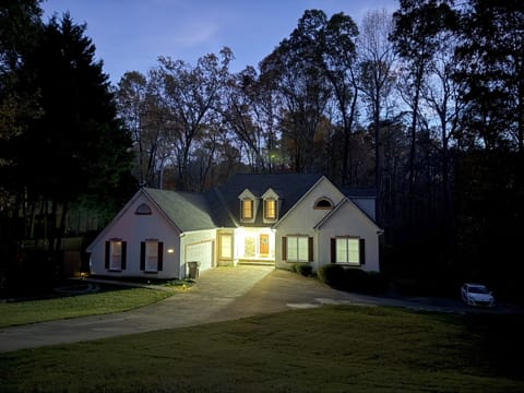 Located in a quiet neighborhood with a big yard and surrounded by lush woodland.