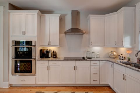 Kitchen is stocked with pots, pans, cups, utensils, and a Keurig!