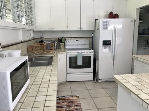 Easy going, well stocked kitchen w/laundry area next to it~ 