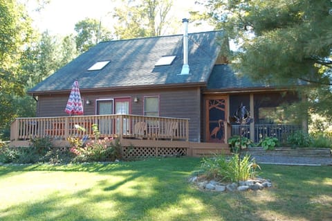 Yard that faces the lake; Adirondack chairs, screened in porch, fire pit