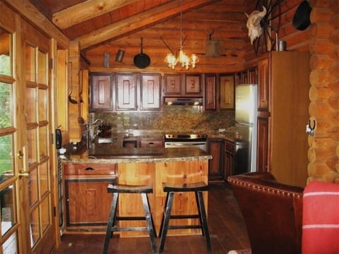 An updated kitchen with stainless steel appliances and granite countertops.