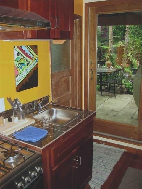 Kitchen with sliding glass door to Private Backyard Patio Garden