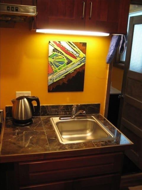 Kitchen area. Original artwork and careful attention to detail throughout.