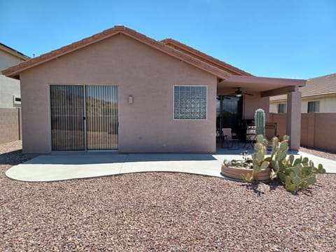Back of house, covered area, chairs, side tables and zero gravity chairs