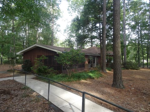 Paved sidewalk all the way down to water with a hand rail