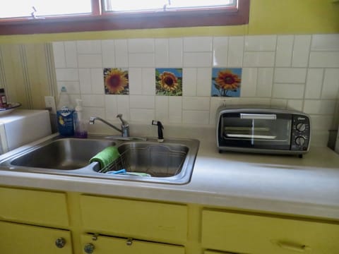 Part of the kitchen with new backsplash and Eve's pictures on tiles. 