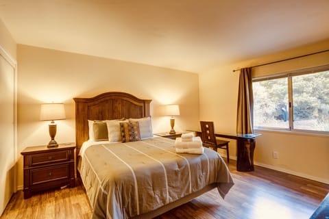 Primary bedroom w/ a desk, closet, TV and console. Ensuite bathroom.