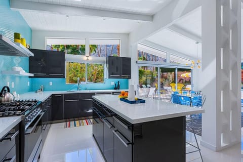 Brightly lit state-of-the-art kitchen with large prep island & bar seating 