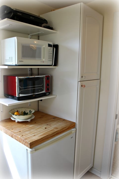 Grill, Microwave, toaster oven, chopping block, frig, and Pantry.