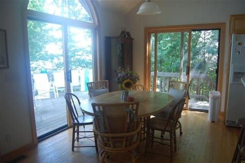 Dining area looking out to deck with overlooks Lake Leelanau