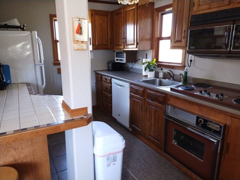 full kitchen stocked with all essentials like pots and pans, dishes and utensils
