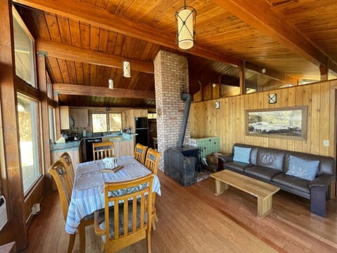 Upstairs has open floor plan with kitchen, dining, living area and wood stove.
