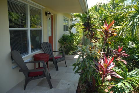 Relax on covered front porch with cascading water fountain & wind chimes.