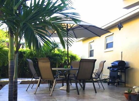 Outdoor dining table w/ umbrella with gas grill