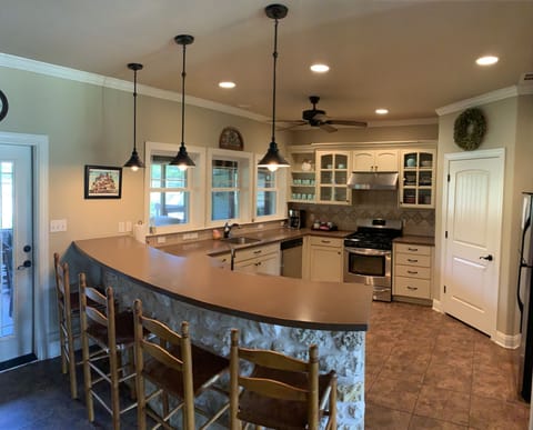 Large Side Kitchen with 2 sinks. Door leading to screen porch and venue.