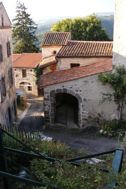view of main entrance - house extends down slope to the hard left turn