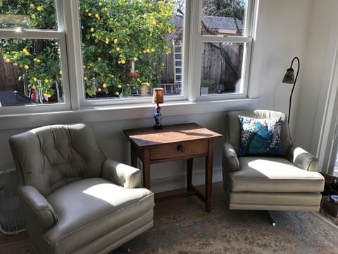 Sunny seating area in master bedroom looking out at prolific lemon tree.