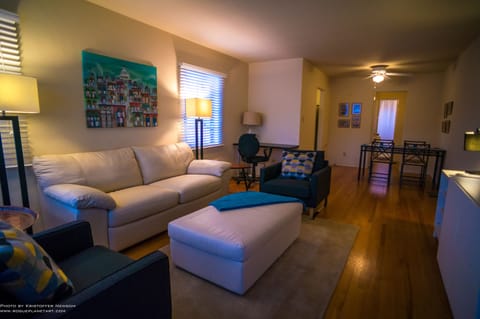 Comfy living room with ivory leather couch and ottoman.  Sleeper couch for 2. 
