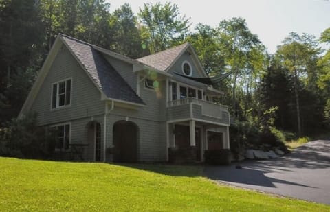Front corner view of the Carriage House shows off the deck and entry portico.