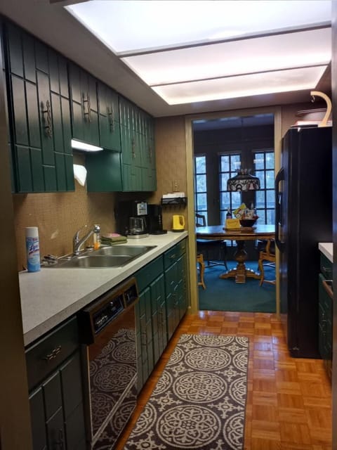 KITCHEN facing dining room, doors to deck, and river - 2021