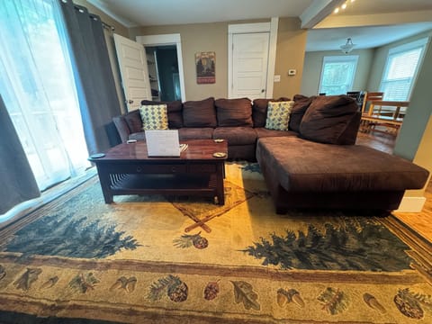 Living room with sectional sofa and table. Sliding glass door out to deck.