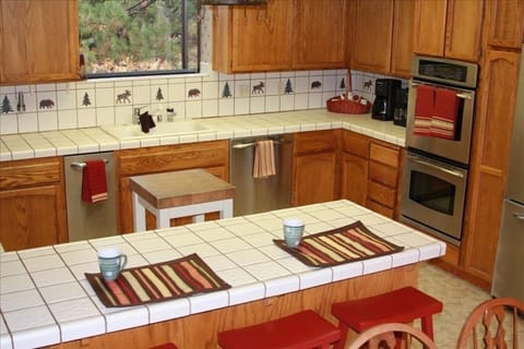 Kitchen with new stainless steel appliances, dual ovens, and breakfast bar!