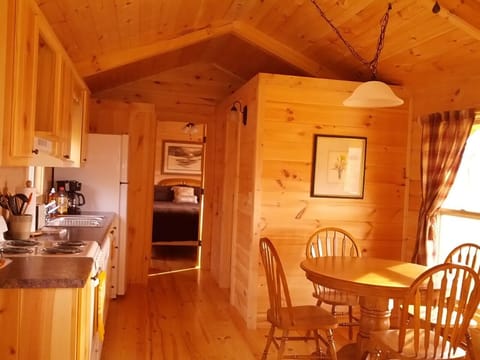 Kitchen and Dining Area with Bedroom in Background