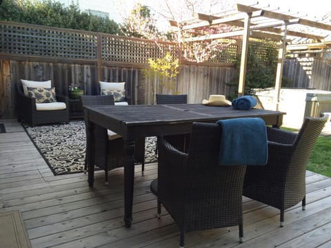 Dining Deck overlooking private back garden with hot tub.