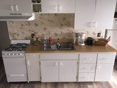 The cottage has a kitchen with all of the amenities to cook patio-side.