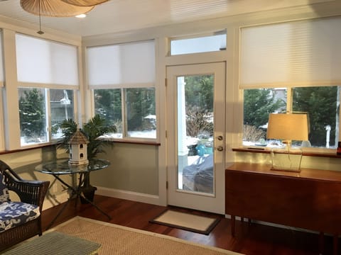 Sun room adjoins master bedroom, dining room, and patio, bringing outdoors in.